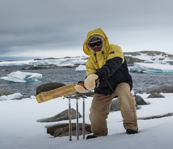 Expeditioner demonstrating the signed cricket bat in use