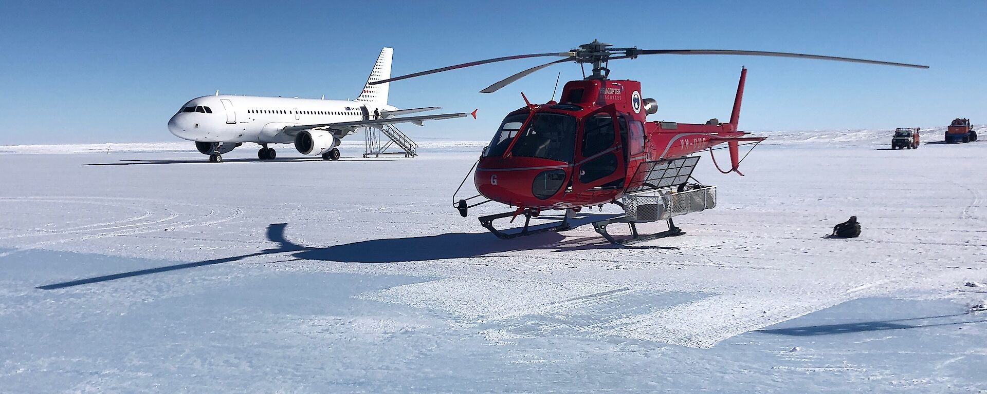 A helicopter and a jet aircraft on an ice runway
