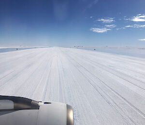 An ice runway looking through an airplane window