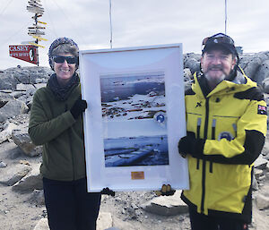 AAD Director Kim Ellis presents Casey station leader Christine MacMillian with a commemorative poster