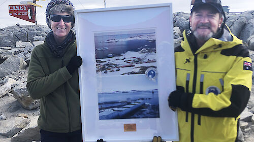 AAD Director Kim Ellis presents Casey station leader Christine MacMillian with a commemorative poster