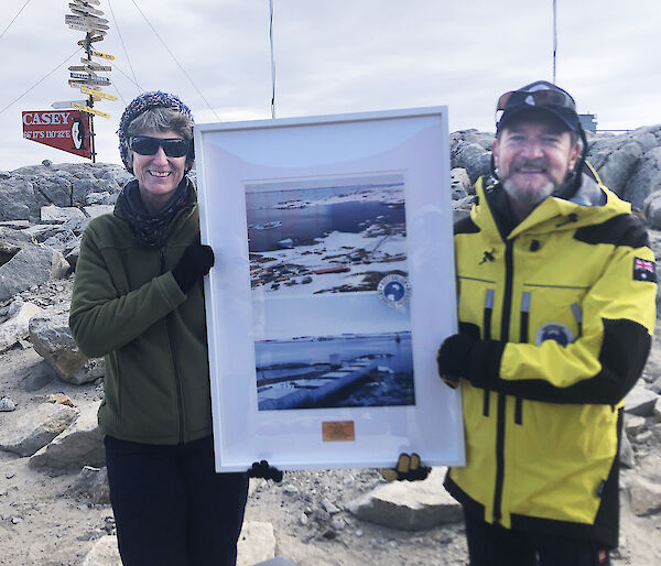 AAD Director Kim Ellis presents Casey station leader Christine MacMillian with a commemorative poster