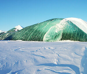 A grounded jade iceberg surrounded by sea ice