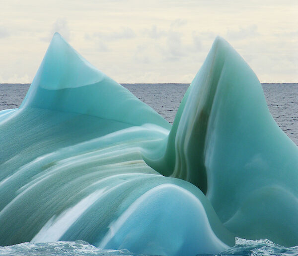 A jade green and white striped iceberg