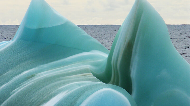 A jade green and white striped iceberg