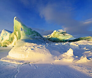 A grounded jade iceberg surrounded by sea ice