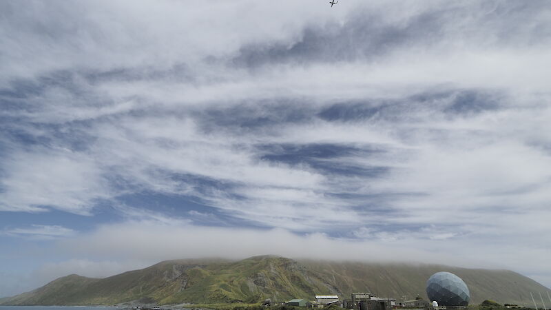 The Dash-8 aircraft flies over Macquarie Island’s isthmus as it conducts a Laser Airborne Depth Sounder (LADS) survey.