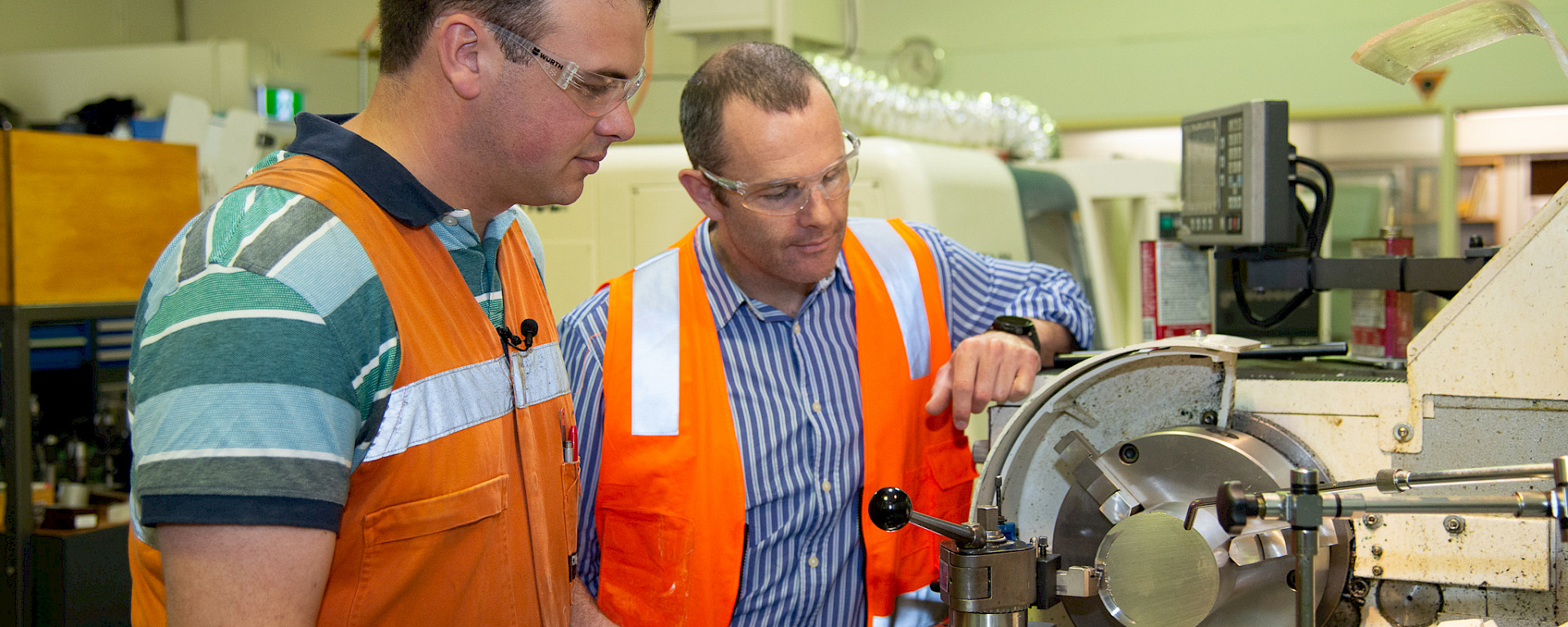 Two men at a lathe