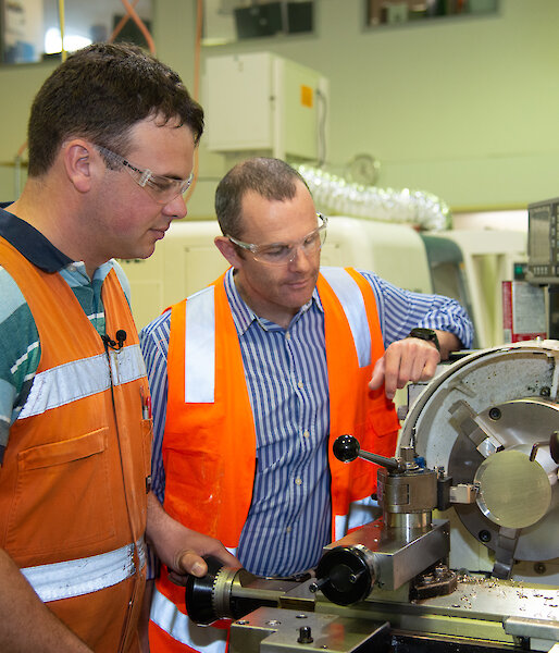 Two men at a lathe