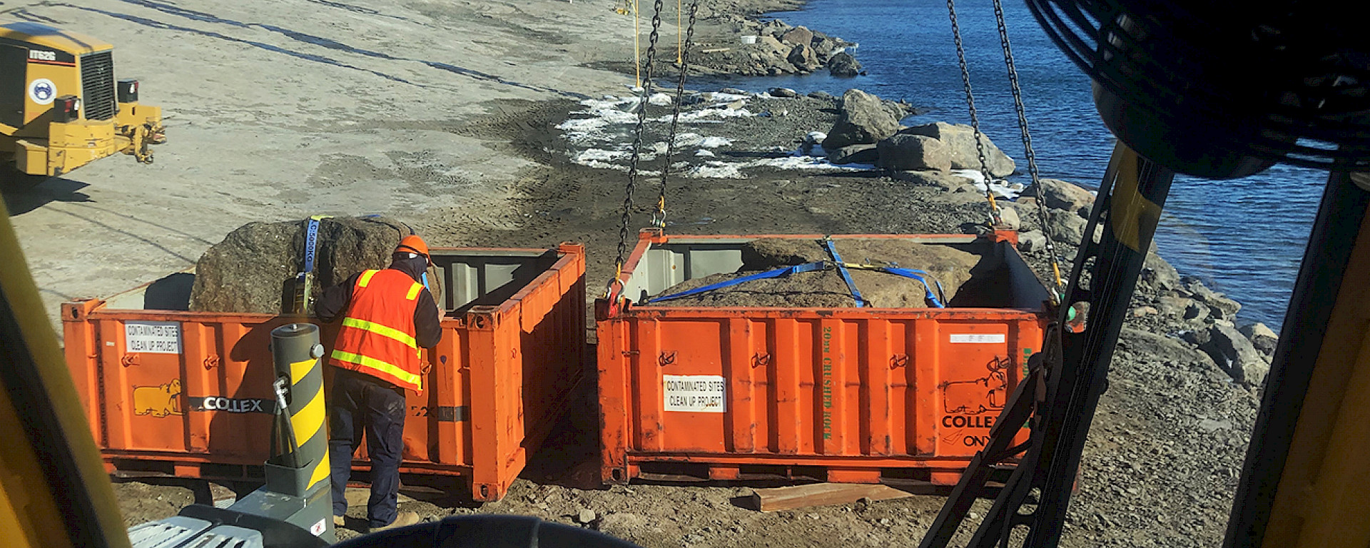 Rocks being craned on to a barge at Mawson research station