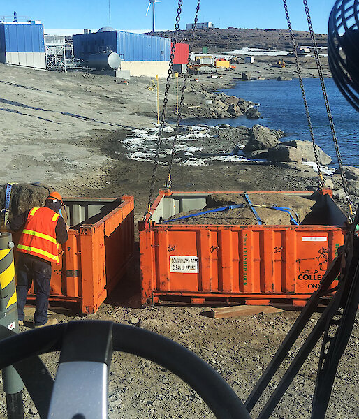 Rocks being craned on to a barge at Mawson research station