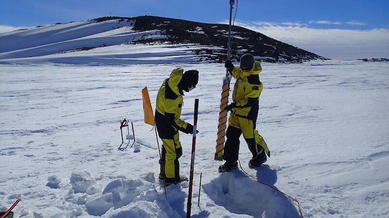 Scientists prepare to extract a fast-ice core to characterize sea-ice properties, including ice-crystal structure, salinity, density or chlorophyll content.