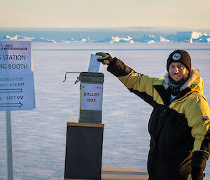 Expeditioner votes with sea ice in background