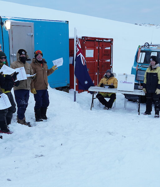 Expeditioners at the polling station on the wharf at Casey research station