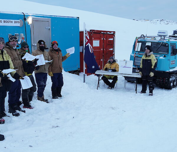 Expeditioners at the polling station on the wharf at Casey research station