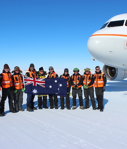 Former Australian Prime Minister Bob Hawke with Australian expeditioners in front of an Airbus A319 on an ice runway.
