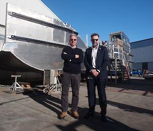 Director of Taylor Bros, Phil Taylor (left), and Australian Antarctic Division Antarctic Modernisation Branch Manager, Rob Bryson, beside one of the Nuyina’s landing barges under construction.