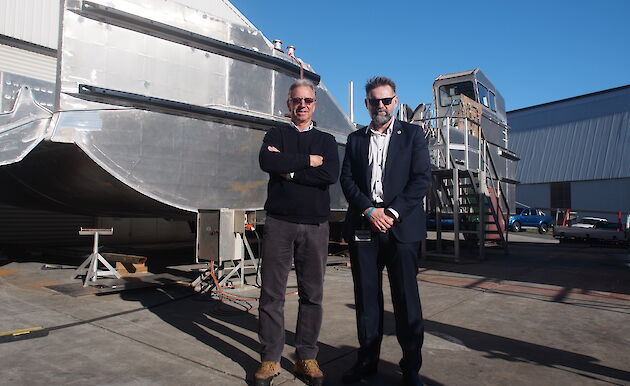 Director of Taylor Bros, Phil Taylor (left), and Australian Antarctic Division Antarctic Modernisation Branch Manager, Rob Bryson, beside one of the Nuyina’s landing barges under construction.