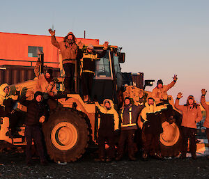 Expeditioners on the loader at sunset