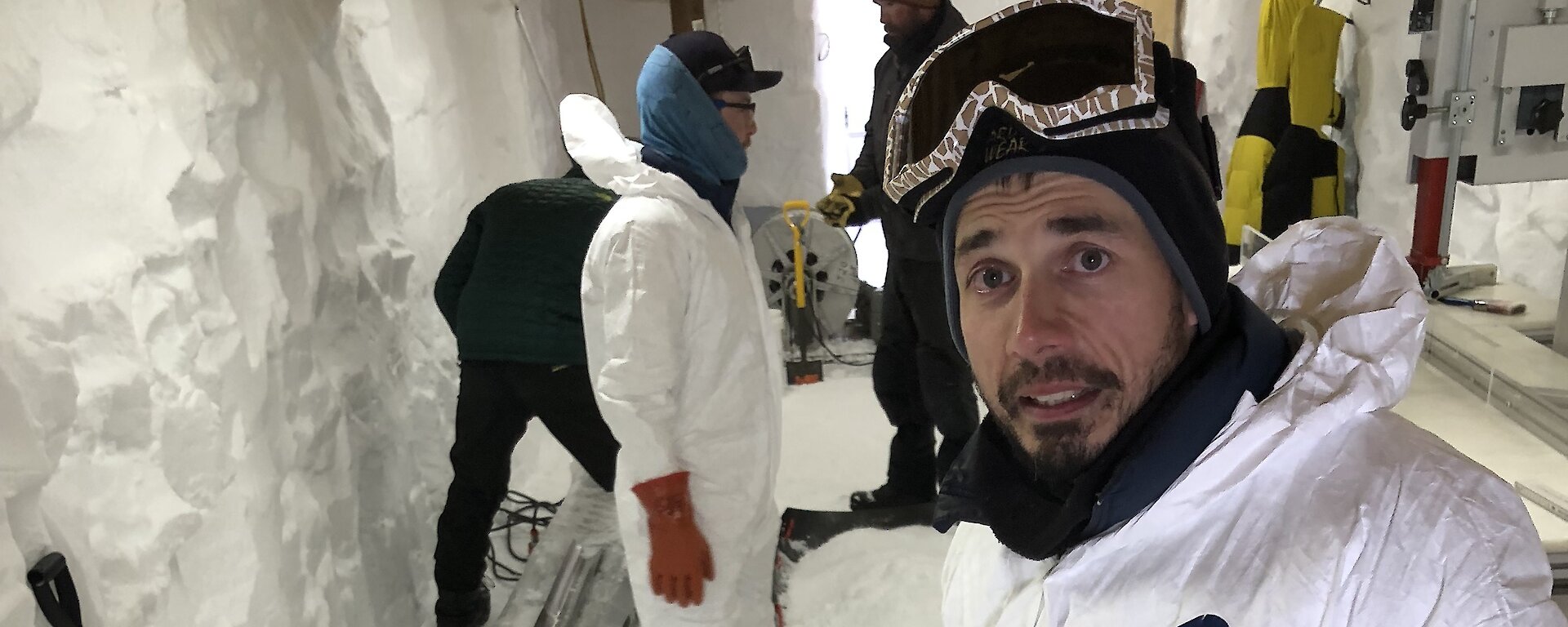 Scientist inside trench with ice drill