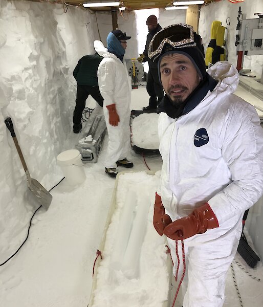 Scientist inside trench with ice drill