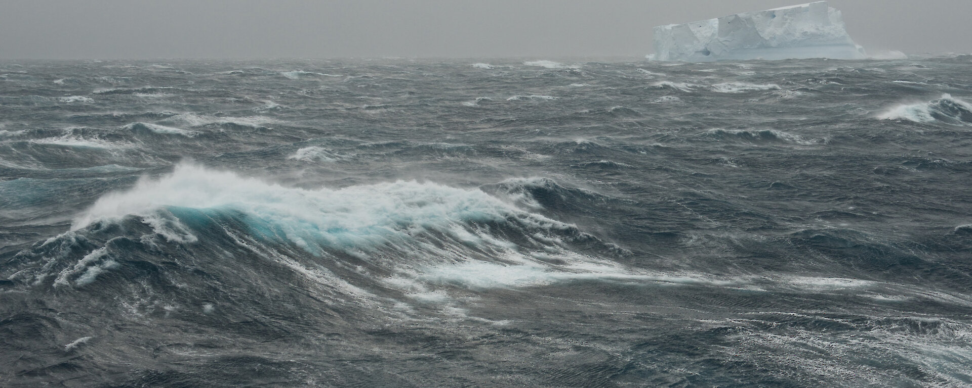 Southern Ocean and iceberg on grey stormy day