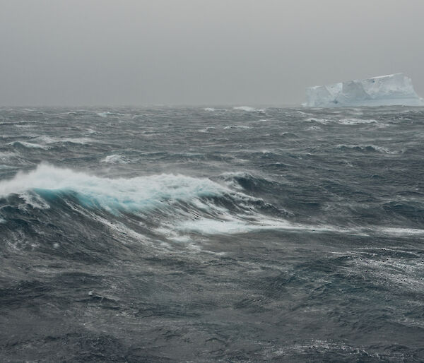 Southern Ocean and iceberg on grey stormy day