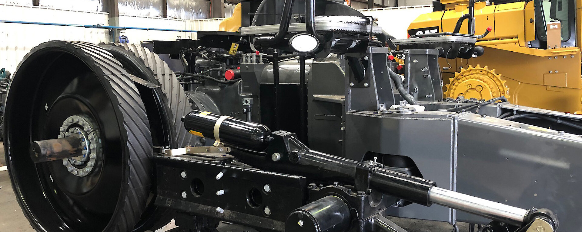 A tractor in workshop in bits, ready to be modified for Antarctic service