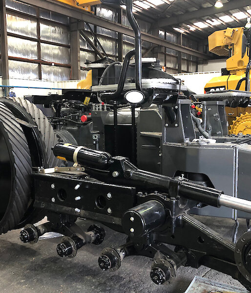 A tractor in workshop in bits, ready to be modified for Antarctic service