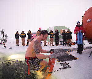 Here we go! Davis research station electrician, Joe Burton, plunging into ice hole