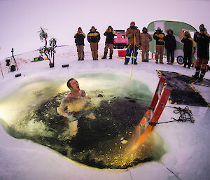 Here we go! Davis research station electrician, Joe Burton, plunging into ice hole