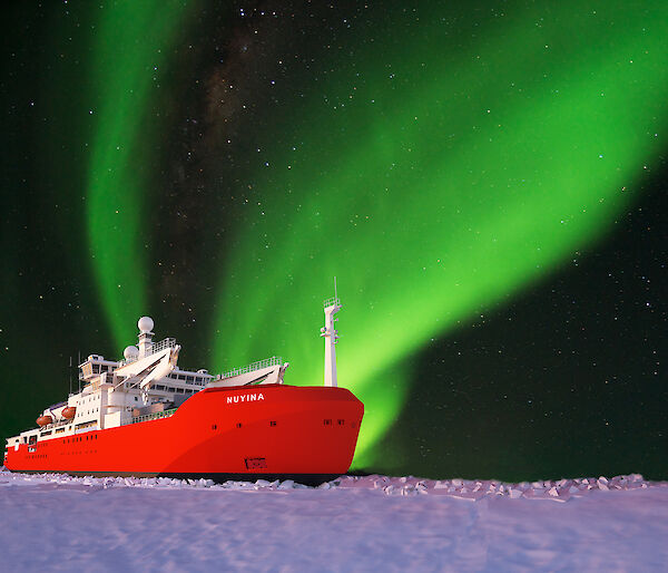 graphic of icebreaker in ice with aurora