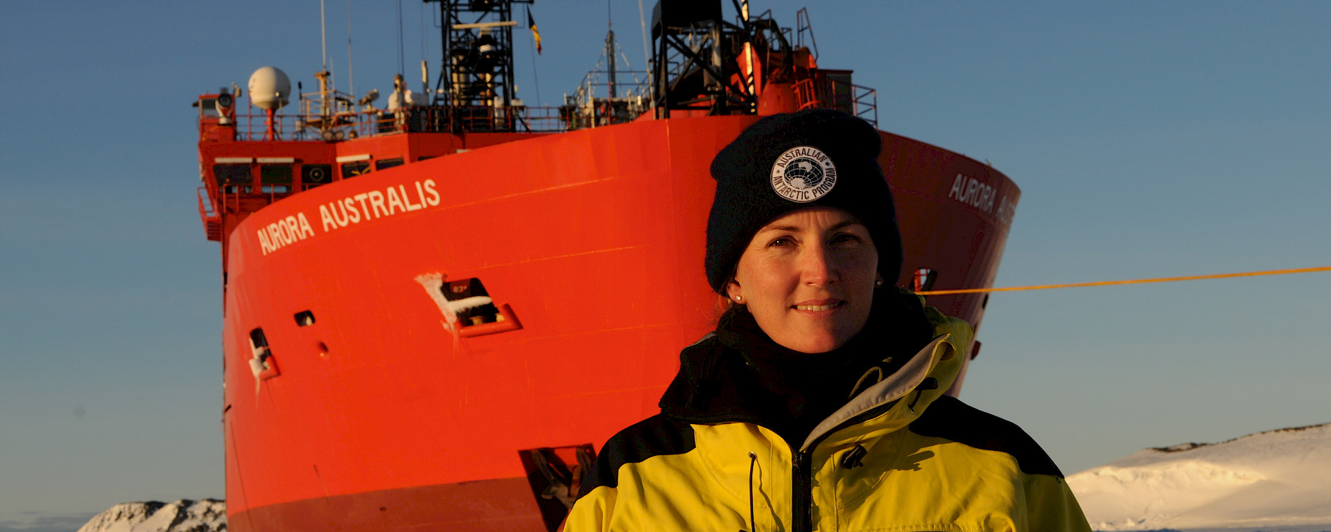 Sarah during her trip to Davis research station in 2017 standing on the sea ice at the bow of the Aurora Australis.