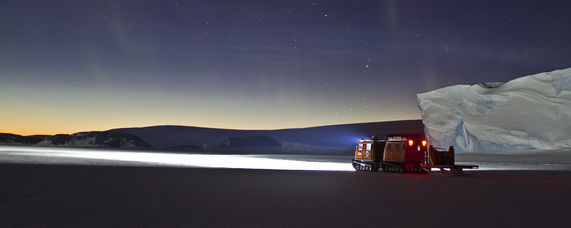 Hägglunds on fast ice at night.
