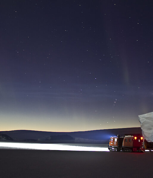 Hägglunds on fast ice at night.