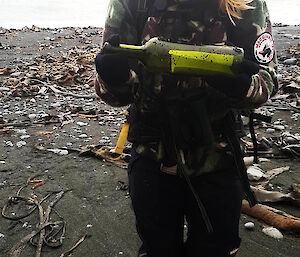 Woman holding a green bottle with paper inside