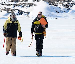 two men walking on sea ice