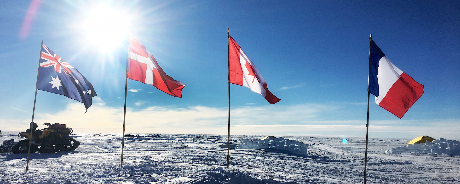 International flags of the participating nations fly over the Mount Brown ice core drill site