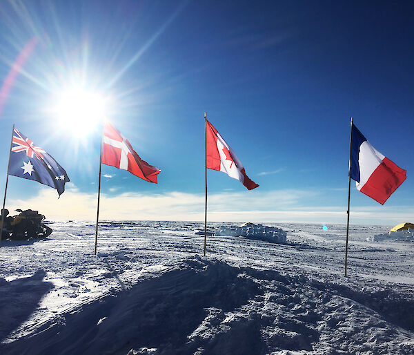 International flags of the participating nations fly over the Mount Brown ice core drill site