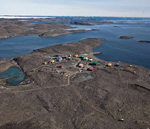 Photo of coloured buildings surrounded by water taken from the air