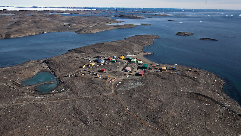 Photo of coloured buildings surrounded by water taken from the air