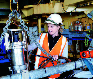 Expeditioner checks underwater camera on the trawl deck of the RSV Aurora Australis