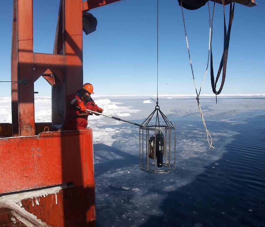 Scientist deploying equipment off RSV Aurora Australis in the Southern Ocean