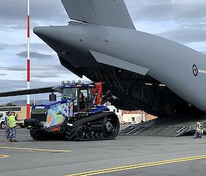 Tractor getting loaded onto the plane