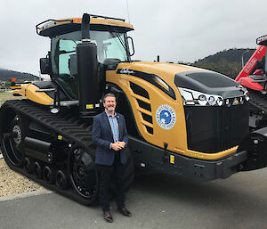 Australian Antarctic Division Director, Kim Ellis with the Caterpillar Challenger tractor before being painted and Ken Done artwork applied