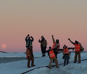 Moon setting behind 7 expeditioners during handover