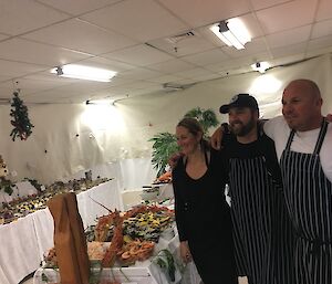 Jordan, Arvid and Justin standing together surrounded by great food