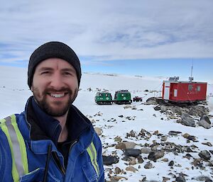 Brendan staning in front of Jack’s Hut with the Green hagg also in the background