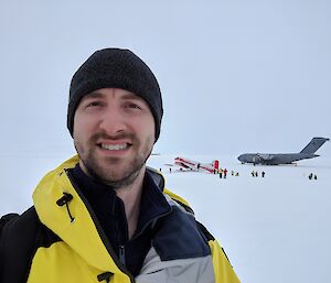 Brendan in the foreground with an Air Force C17 behind him on the ice runway