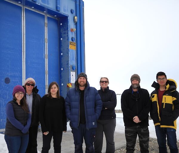 2018/19 Met Team standing in front of the balloon building including (from left to right) Deb, Tanya, Nyssa, Sean, Jane, Craig and Ken.